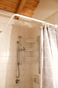 a shower with a shower curtain in a bathroom at Da Giorgio a Tremalzo in Ledro
