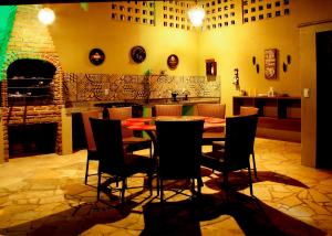 a dining room with a table and chairs at Pousada da Luz in Aquiraz