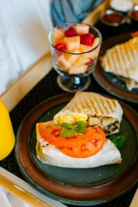 a plate of food with a sandwich and a bowl of fruit at Pine River Ranch B&B in Leavenworth