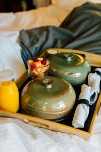 a tray with two green dishes and a bowl of fruit at Pine River Ranch B&B in Leavenworth