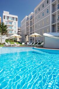 a large swimming pool in front of a building at Marques Best Apartments | Lisbon Best Apartments in Lisbon