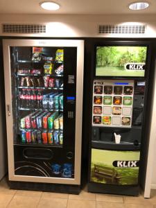 two soda machines sitting next to each other at hotelF1 Saverne Monswiller in Monswiller