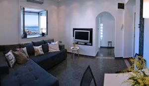 a living room with a couch and a flat screen tv at Aurora Apartment in Rijeka