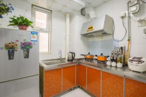 a kitchen with a sink and a refrigerator at Jinan Shizhong·Baotu Spring· Locals Apartment 00113540 in Jinan