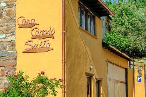 a yellow building with a sign on the side of it at Casa Canedo Suite in San Juan de la Mata