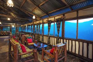 a train car with chairs and tables and windows at Gorilla Closeup Lodge in Kisoro