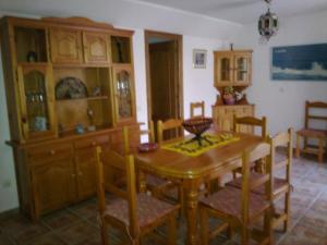 a dining room with a wooden table and chairs at Casas Cueva Paloma in Los Carriones