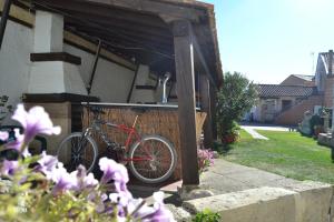 una bicicleta roja estacionada fuera de una casa en Amanecer en Campos, en Población de Campos