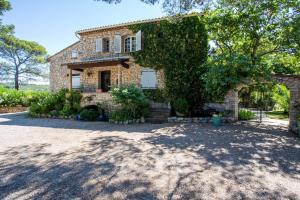 a large stone house with a large driveway at Domaine L'Helion in Taradeau