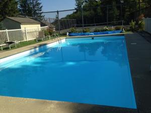 a large blue swimming pool in a yard at Beautifully decorated, 3 bedroom 2 bedroom condo is moments away from the Base Lodges Whiffletree D2 in Killington
