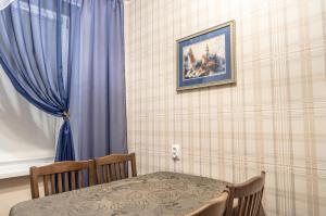 マグニトゴルスクにあるLenina 116のダイニングルーム(テーブル、青いカーテン付)