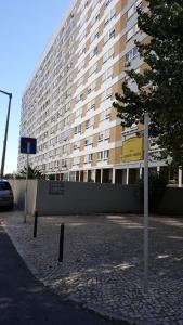 a large building with a parking lot in front of it at Apartment in Portela near the Airport in Lisbon