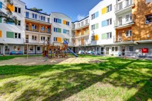 a playground in the courtyard of a apartment building at Apartamenty Poddąbek in Poddąbie