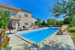 a swimming pool in front of a villa at Holiday Home M&M in Benkovac