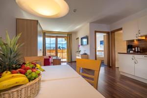 费斯奥罗拉费斯公寓酒店的厨房以及用餐室,配有带水果的桌子。