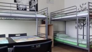 a room with two bunk beds and a desk at Art Hostel in Kraków