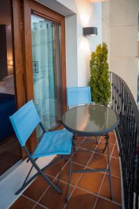 two chairs and a table on a balcony at Hotel Boutique Barra Alta (Adults Only) in Peniscola