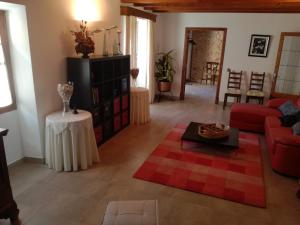 a living room with a red couch and a table at Pina in Pina