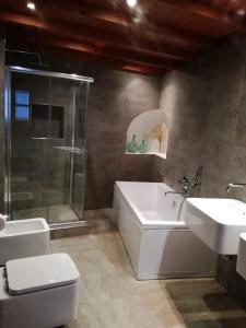 a bathroom with a toilet and a sink and a shower at Pina in Pina