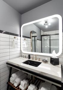 a bathroom with a sink and a mirror at The Chicago Hotel Collection Wrigleyville in Chicago