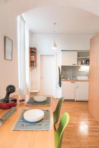 a kitchen and dining room with a table and chairs at Ella's River Apartment in Ljubljana