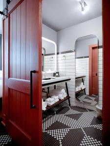 a bathroom with a red door and a sink at The Chicago Hotel Collection Wrigleyville in Chicago