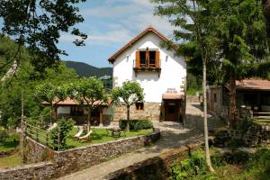 
a small house with a large window at Hotel Rural Besaro - Selva de Irati in Izalzu
