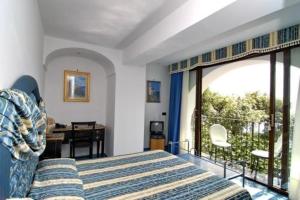 a bedroom with a bed and a balcony at Albergo La Conca Azzurra in Conca dei Marini