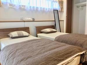 A-Style Futenma客房内的一张或多张床位
