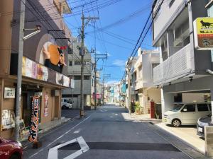 an empty street in an alley between buildings at A-Style Futenma in Ginowan
