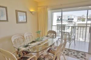 a dining room with a table and chairs and a balcony at Placida Condo #12279 in Placida