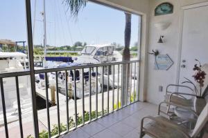 a balcony with a view of a marina with a boat at Placida Condo #12279 in Placida