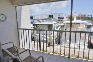 a balcony with chairs and a view of a marina at Placida Condo #12279 in Placida