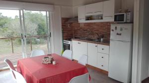 a kitchen with a table with a red table cloth at Bramasole Serrano in Villa Serrana