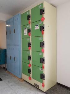 a row of lockers with red tags on them at Guest House M104 Kagoshima in Kagoshima