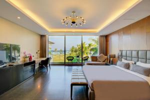 a hotel room with a bed and a desk and a kitchen at The Five Stars Villa 7 Bedrooms Beachfront in Danang