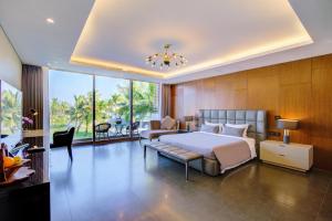 a large bedroom with a bed and a couch at The Five Stars Villa 7 Bedrooms Beachfront in Danang +92 photos