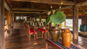 a dining room with a table and a vase at Lak Tented Camp in Lien Son