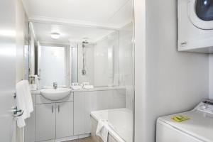 a white bathroom with a sink and a toilet at MainStay Suites Williamstown in Williamstown +41 photos