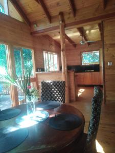 a wooden dining room with a table and chairs at Mango Cottage in Horseshoe Bay