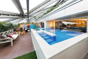 a swimming pool in the middle of a house at Hotel Éclat Beijing in Beijing
