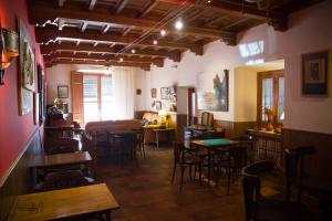 a room with tables and chairs in a restaurant at La Casona del Abuelo Parra in Villanueva de los Infantes