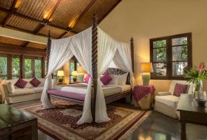 a bedroom with a bed with a canopy at Jeeva Saba Bali in Saba