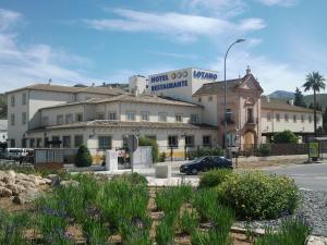 a building with a sign on top of it at Hotel Lozano in Antequera