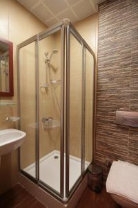 a shower with a glass door in a bathroom at Konya Dervish Hotel in Konya
