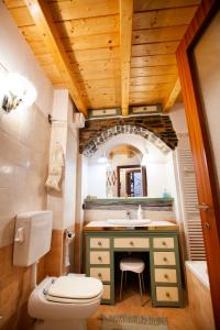 a bathroom with a sink and a toilet and a mirror at Antica Molina in Faggeto Lario 