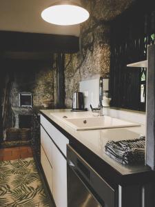 a kitchen with a sink and a counter at Casa da Cresso in Amares