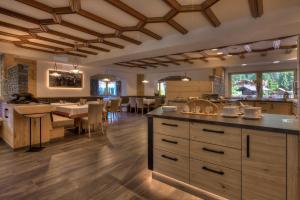 a large kitchen and dining room with a dining table at Hotel Residence Rose in Vipiteno