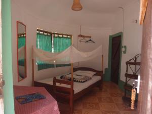 a bedroom with a bunk bed and a mirror at Salem Uganda Guesthouse in Mbale