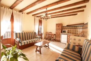 a living room with two couches and a table at Apartamentos Los Hebiles in Jerte